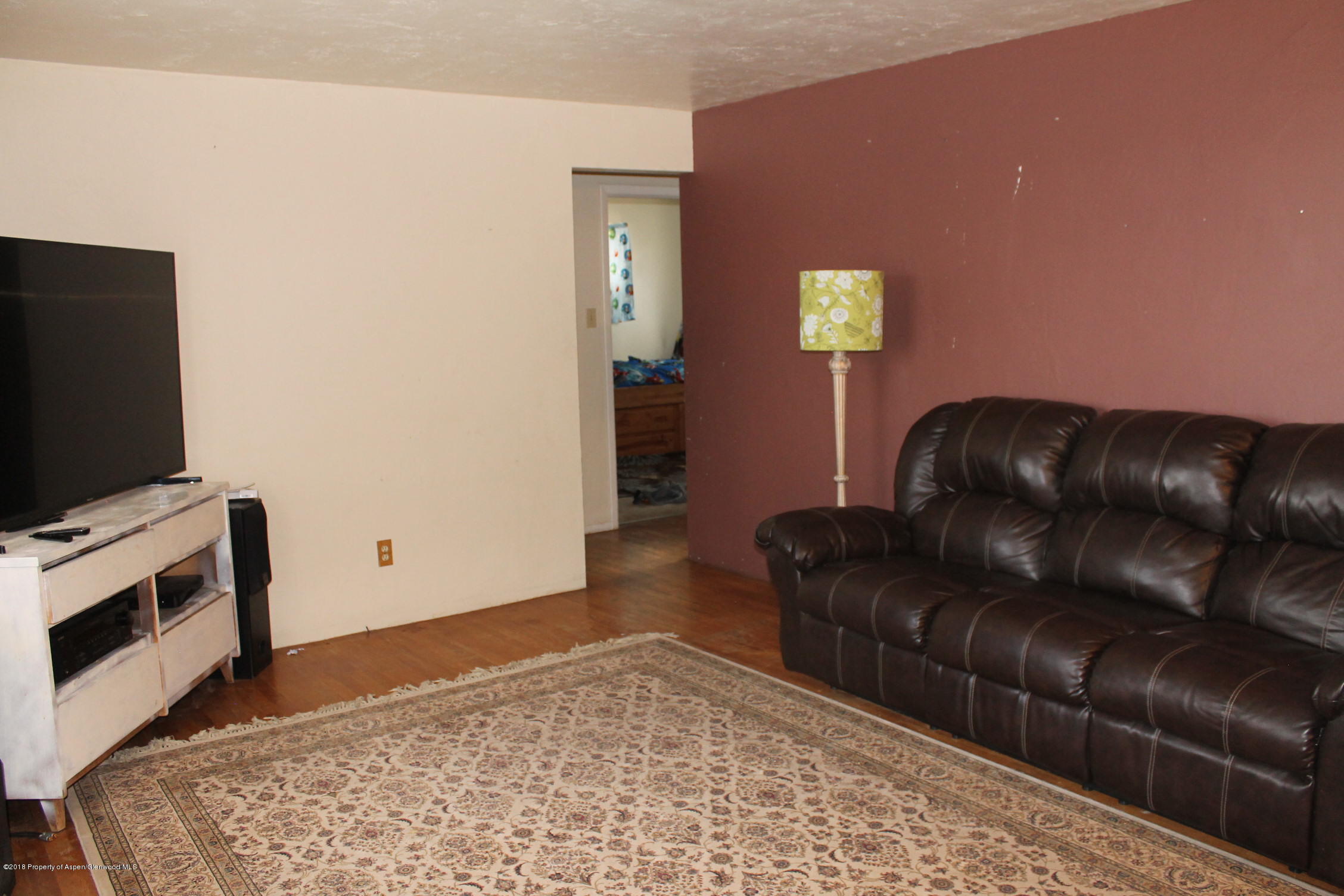 405 Ute Avenue Rifle, CO 81650 - Photo 3 of 21 a living room with furniture and a flat screen tv