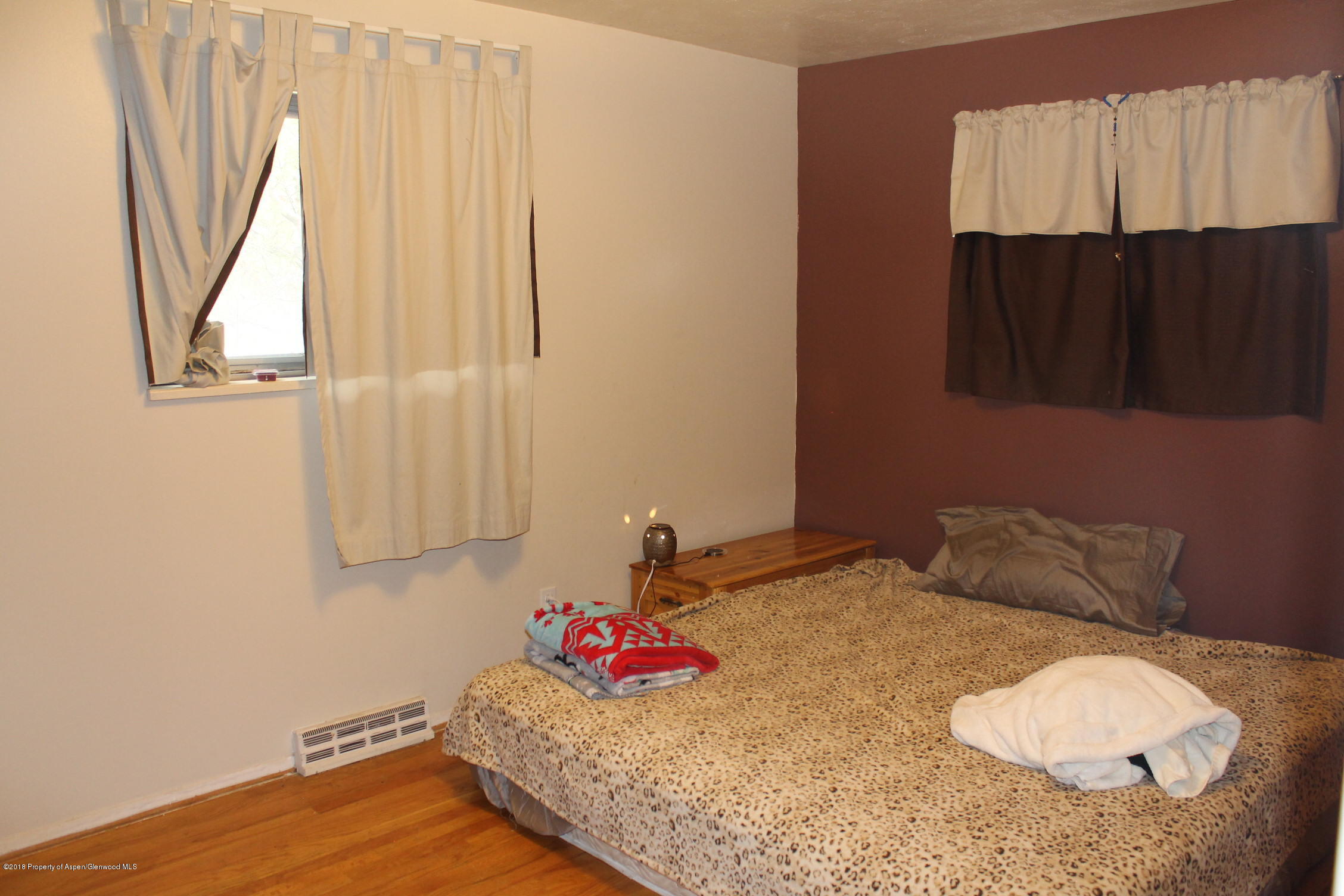 405 Ute Avenue Rifle, CO 81650 - Photo 5 of 21 a bedroom with a bed and a window