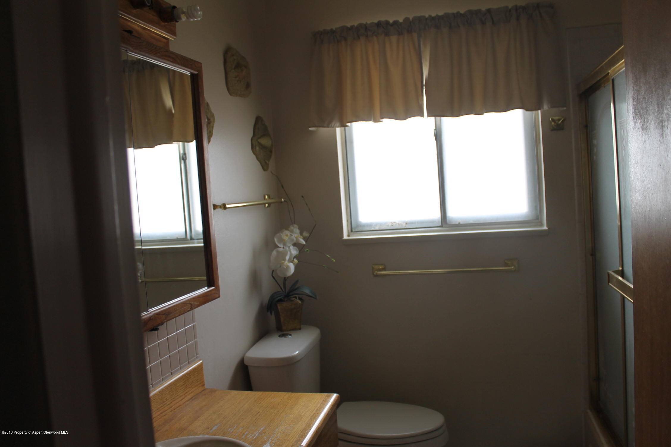 405 Ute Avenue Rifle, CO 81650 - Photo 7 of 21 a bathroom with a toilet sink and window