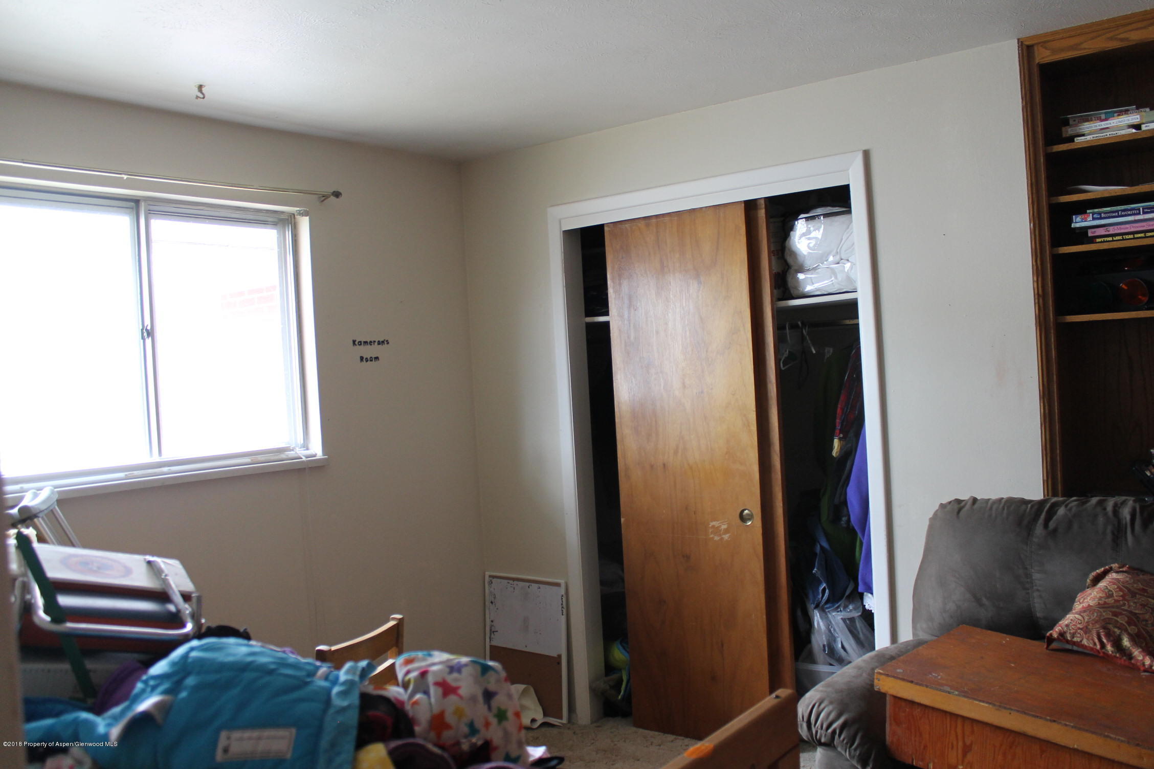 405 Ute Avenue Rifle, CO 81650 - Photo 8 of 21 a bedroom with a bed and a couch