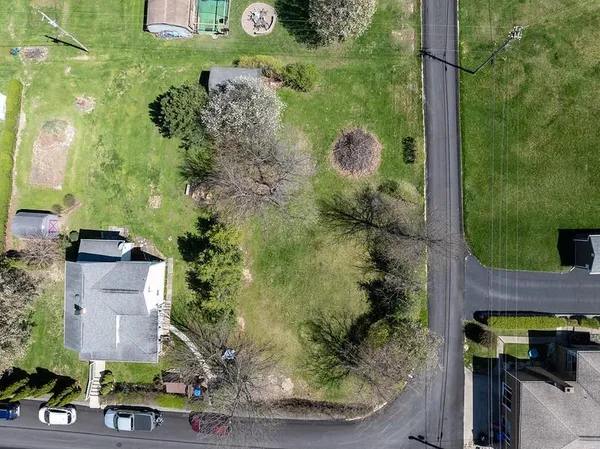 an aerial view of a residential houses with outdoor space