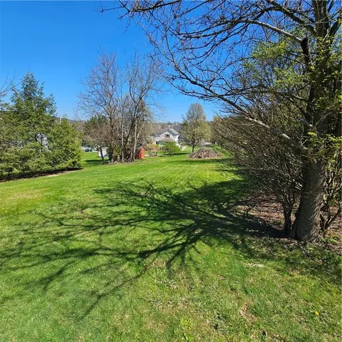 a view of a field with an trees