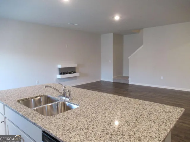 a kitchen with a sink and a refrigerator