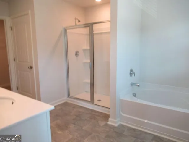 a spacious bathroom with double sink and mirror