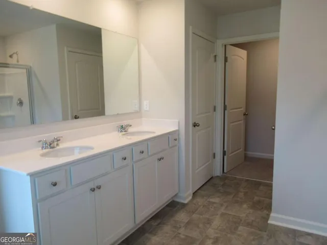 a white toilet sitting next to a white wall