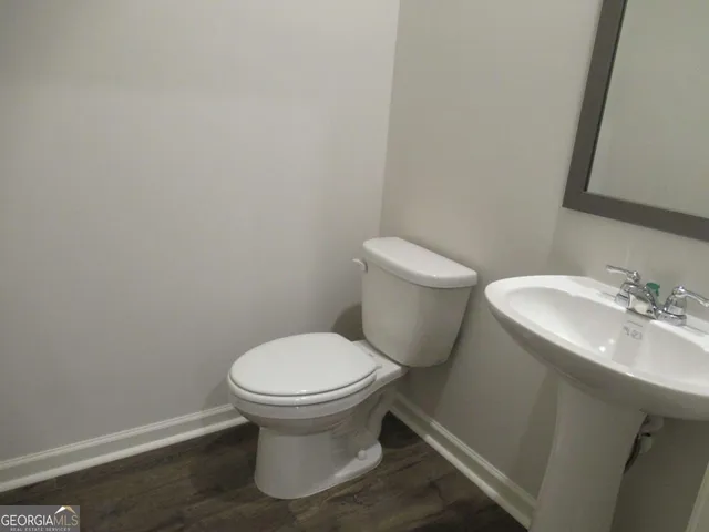 a white toilet sitting next to a bathroom sink