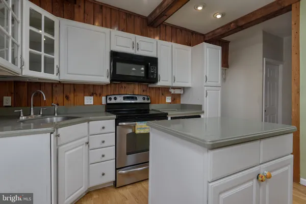 a kitchen with stainless steel appliances granite countertop a sink a stove and a refrigerator