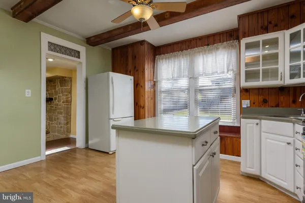 a kitchen with a refrigerator and a sink