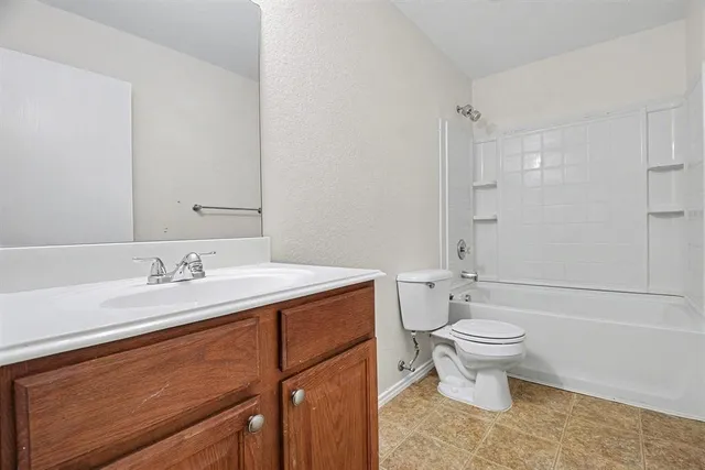 a bathroom with a sink toilet a mirror and shower