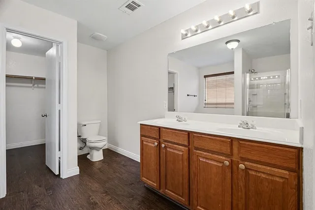 a spacious bathroom with a sink and a mirror