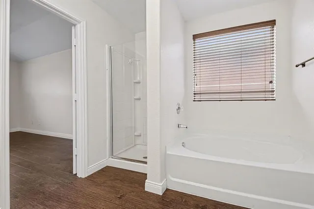 a bathroom with a bathtub and shower