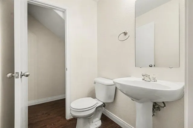 a bathroom with a sink toilet and a mirror
