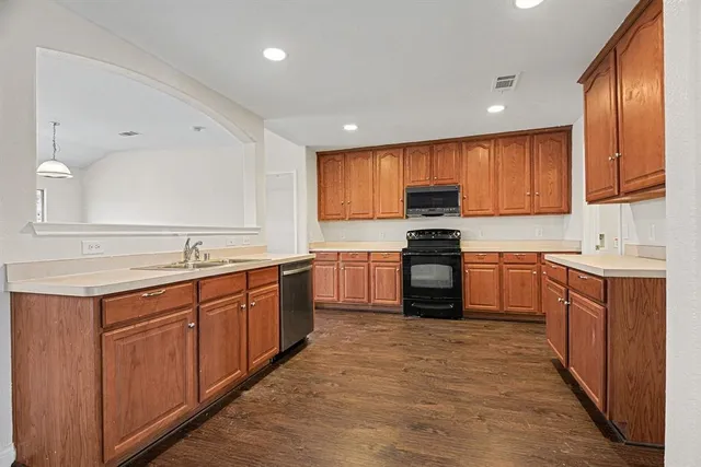 a kitchen with granite countertop stainless steel appliances and wooden cabinets