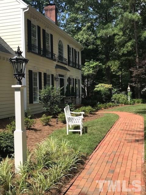 8108 Windsor Ridge Drive Raleigh, NC 27615 - Photo 2 of 25 a view of a house with backyard sitting area and garden