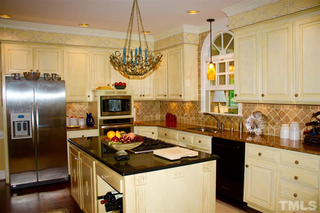 8108 Windsor Ridge Drive Raleigh, NC 27615 - Photo 22 of 25 a kitchen with stainless steel appliances granite countertop a stove and a sink