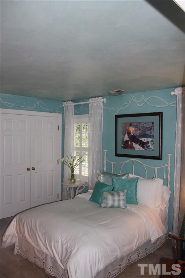8108 Windsor Ridge Drive Raleigh, NC 27615 - Photo 7 of 25 a bedroom with a bed and a painting on the wall