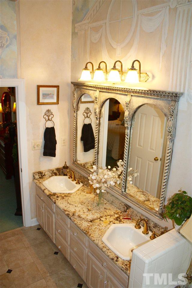 8108 Windsor Ridge Drive Raleigh, NC 27615 - Photo 9 of 25 a bathroom with a granite countertop sink and a mirror
