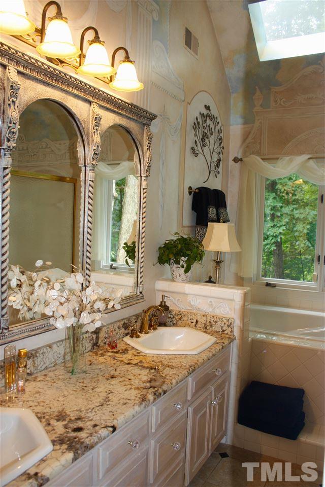 8108 Windsor Ridge Drive Raleigh, NC 27615 - Photo 10 of 25 a bathroom with a granite countertop sink a toilet and a mirror