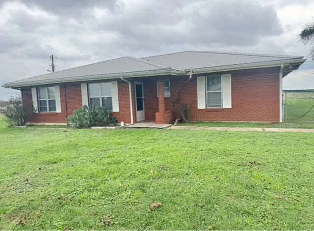 a front view of house with yard and green space