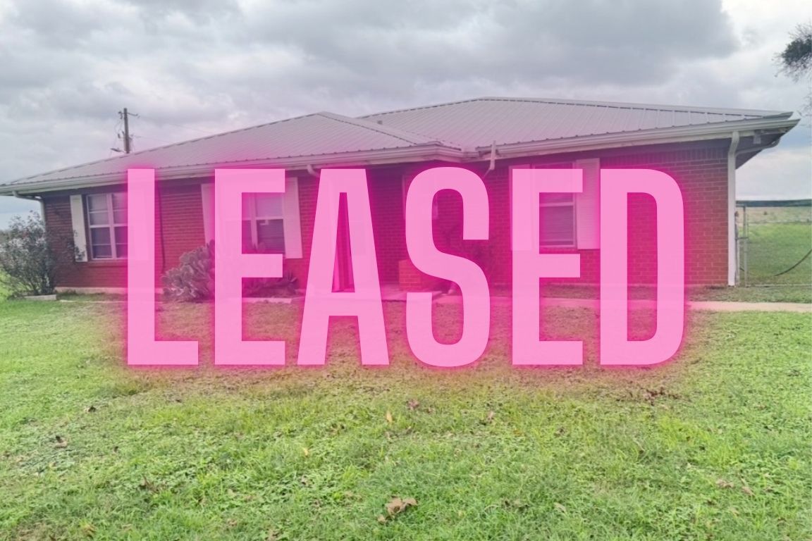 a sign board with a yard