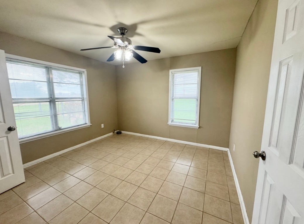 110 Marek Road Elgin, TX 78621 - Photo 13 of 27 an empty room with windows and fan