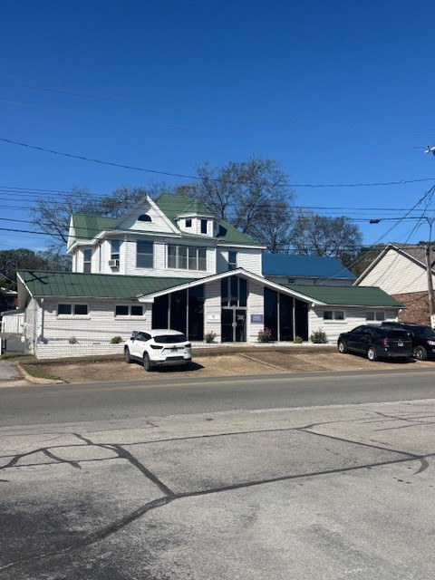 118 North 3rd Street, Unit 1 Pulaski, TN 38478 - Photo 1 of 15 a front view of a house with a yard and balcony