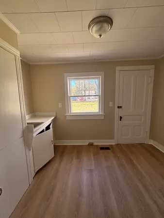 a view of a kitchen with a dishwasher cabinets and a window