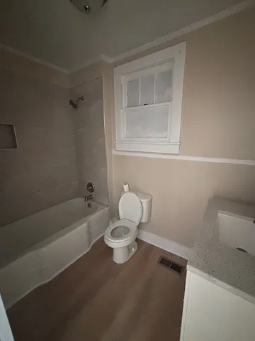 a bathroom with a sink a toilet and bathtub