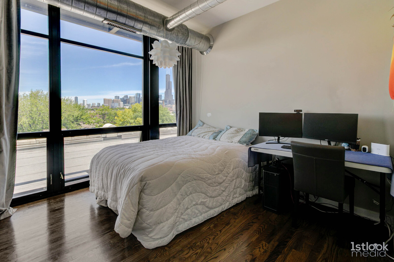 1033 West 14th Place, Unit 413 Chicago, IL 60608 - Photo 11 of 42 a bed sitting in a bedroom next to a window