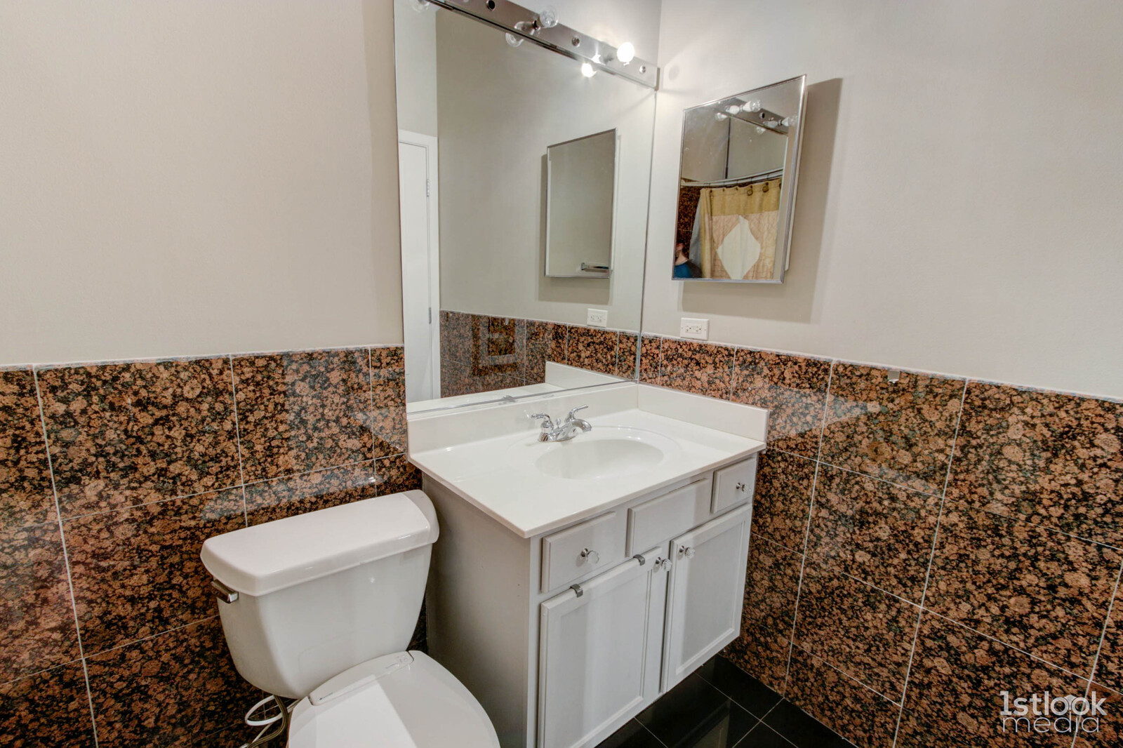 1033 West 14th Place, Unit 413 Chicago, IL 60608 - Photo 14 of 42 a bathroom with a sink toilet and mirror