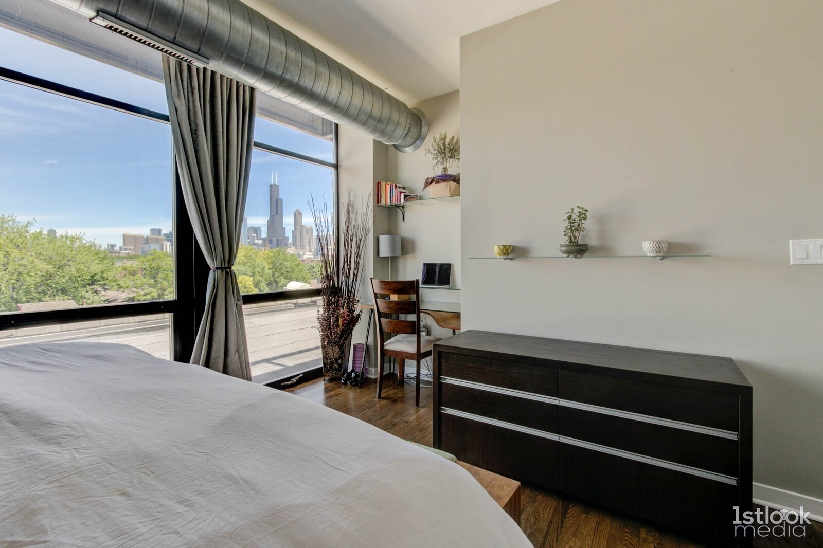 1033 West 14th Place, Unit 413 Chicago, IL 60608 - Photo 16 of 42 a bedroom with a bed and wooden floor