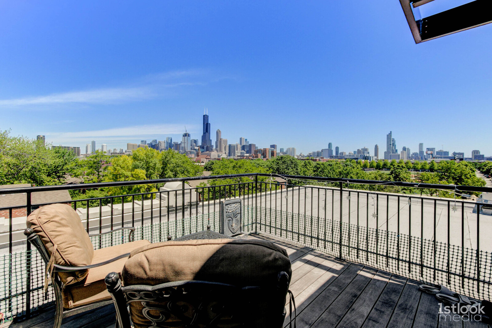 1033 West 14th Place, Unit 413 Chicago, IL 60608 - Photo 22 of 42 a view of a balcony with wooden chairs and city view