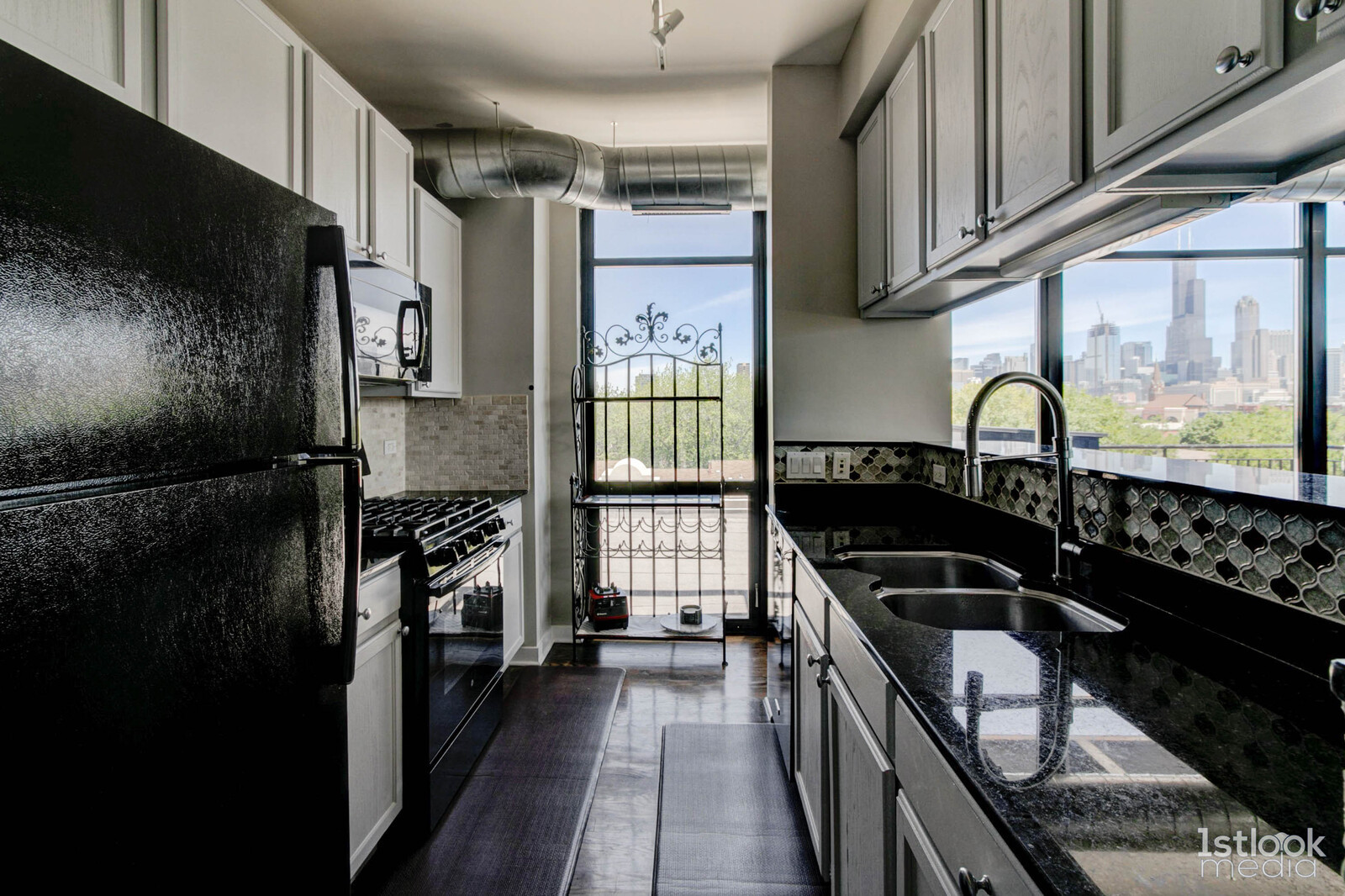 1033 West 14th Place, Unit 413 Chicago, IL 60608 - Photo 9 of 42 a kitchen with granite countertop a stove a sink and a refrigerator