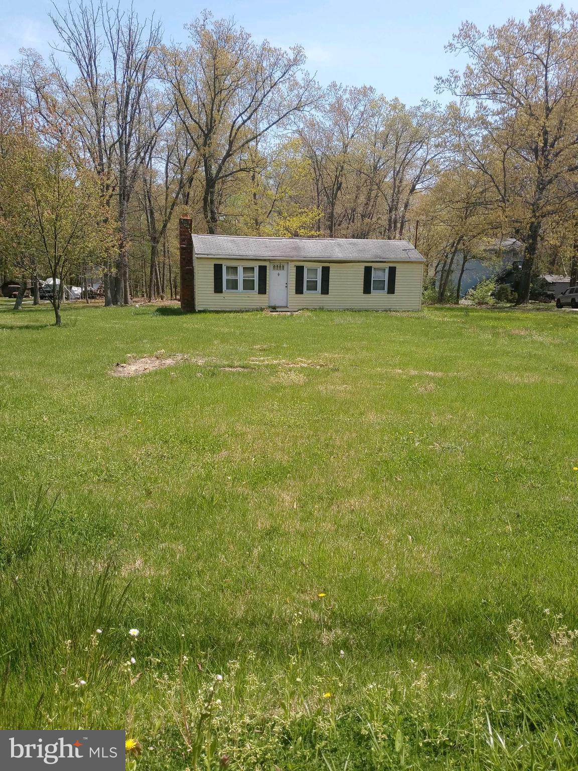 a view of house with yard in front of house