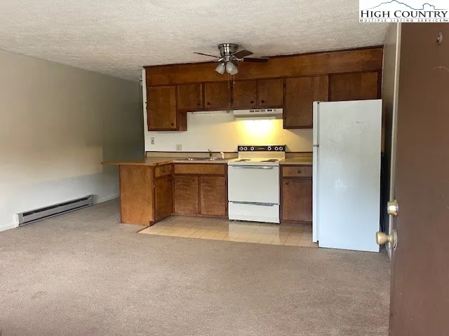 a kitchen with stainless steel appliances a refrigerator and a stove