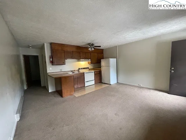 a kitchen with stainless steel appliances a refrigerator and a stove top oven