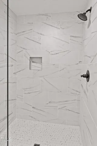 an aerial view of a house with a yard and lake view