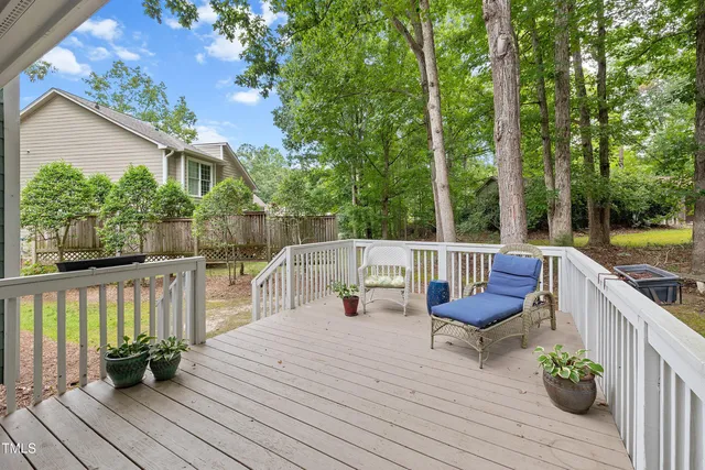 an aerial view of residential houses with outdoor space and trees