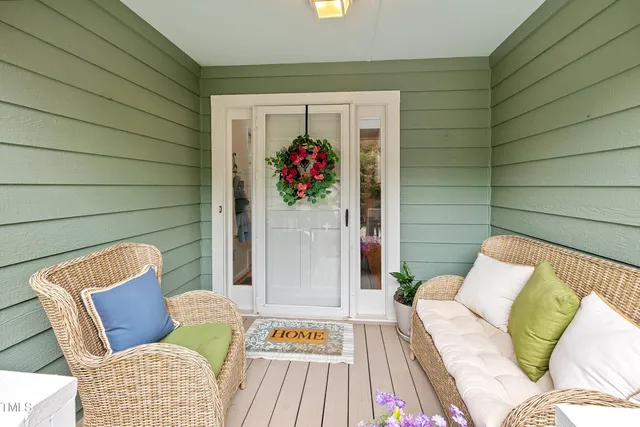 a hallway with painting on the table and a potted plants