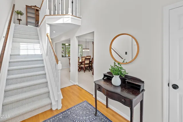 a kitchen with white cabinets stainless steel appliances a sink and a window