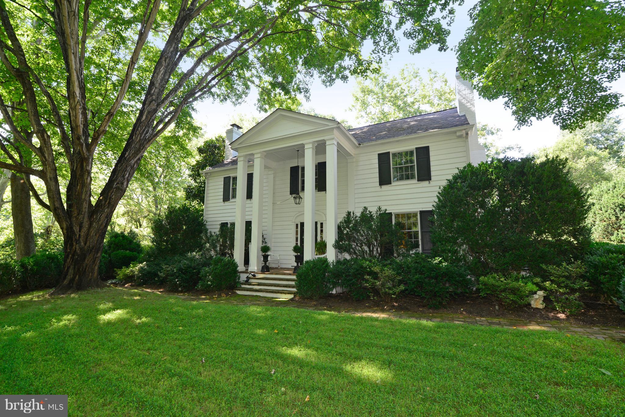 a front view of house with a garden