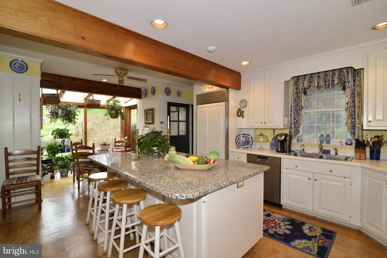 3072 Swift Shoals Road Boyce, VA 22620 - Photo 11 of 30 a kitchen with granite countertop lots of white furniture a dining table and chairs