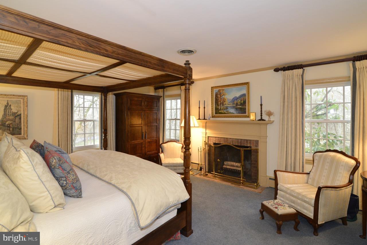 3072 Swift Shoals Road Boyce, VA 22620 - Photo 19 of 30 a spacious bedroom with a bed and a fireplace