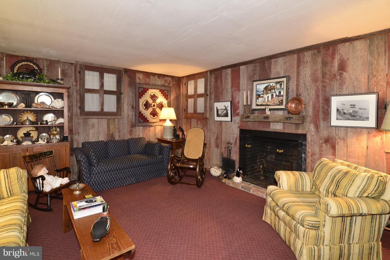 3072 Swift Shoals Road Boyce, VA 22620 - Photo 25 of 30 a living room with furniture a lamp and a fireplace