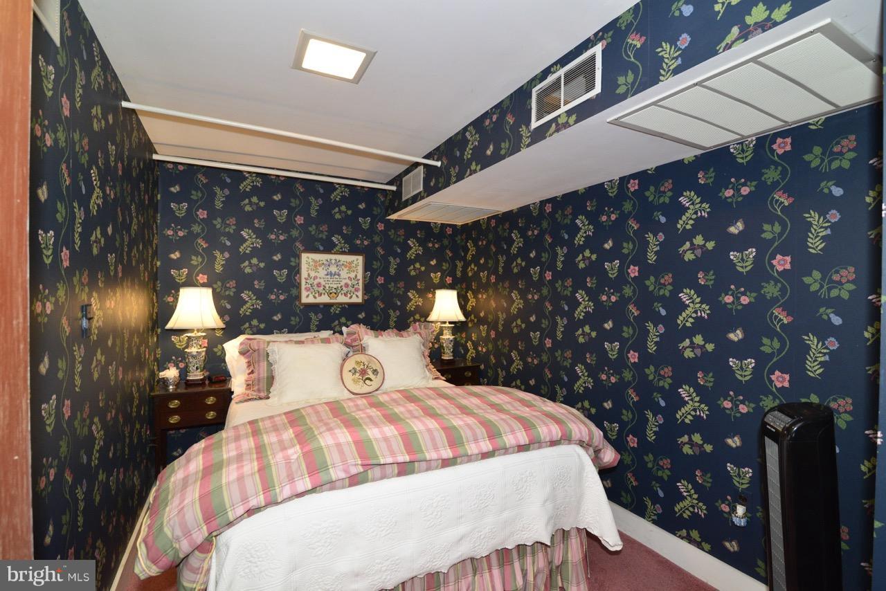 3072 Swift Shoals Road Boyce, VA 22620 - Photo 26 of 30 a bed sitting in a bedroom next to a lamp