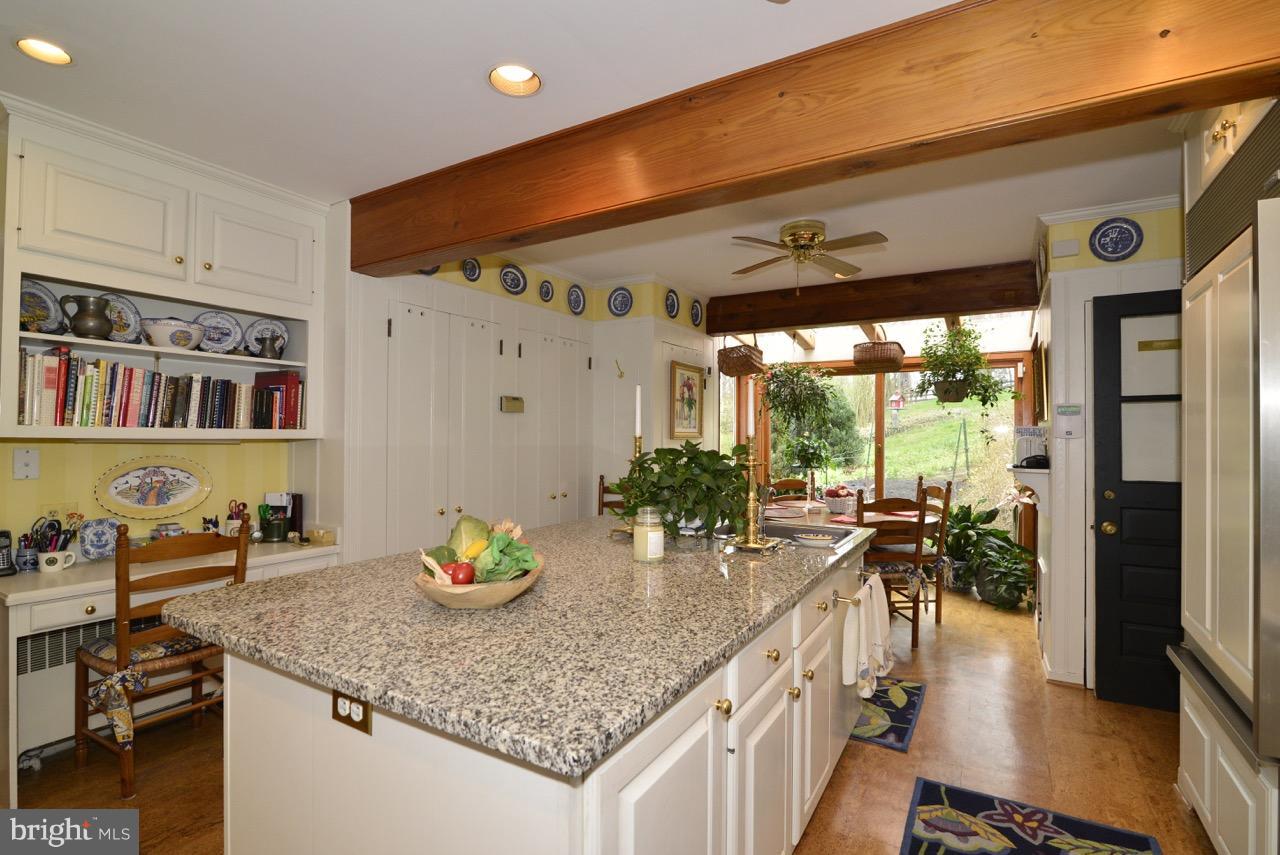 3072 Swift Shoals Road Boyce, VA 22620 - Photo 10 of 30 a kitchen with stainless steel appliances granite countertop a sink a stove and a wooden floors