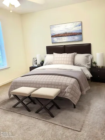 a bedroom with a bed a table and chair