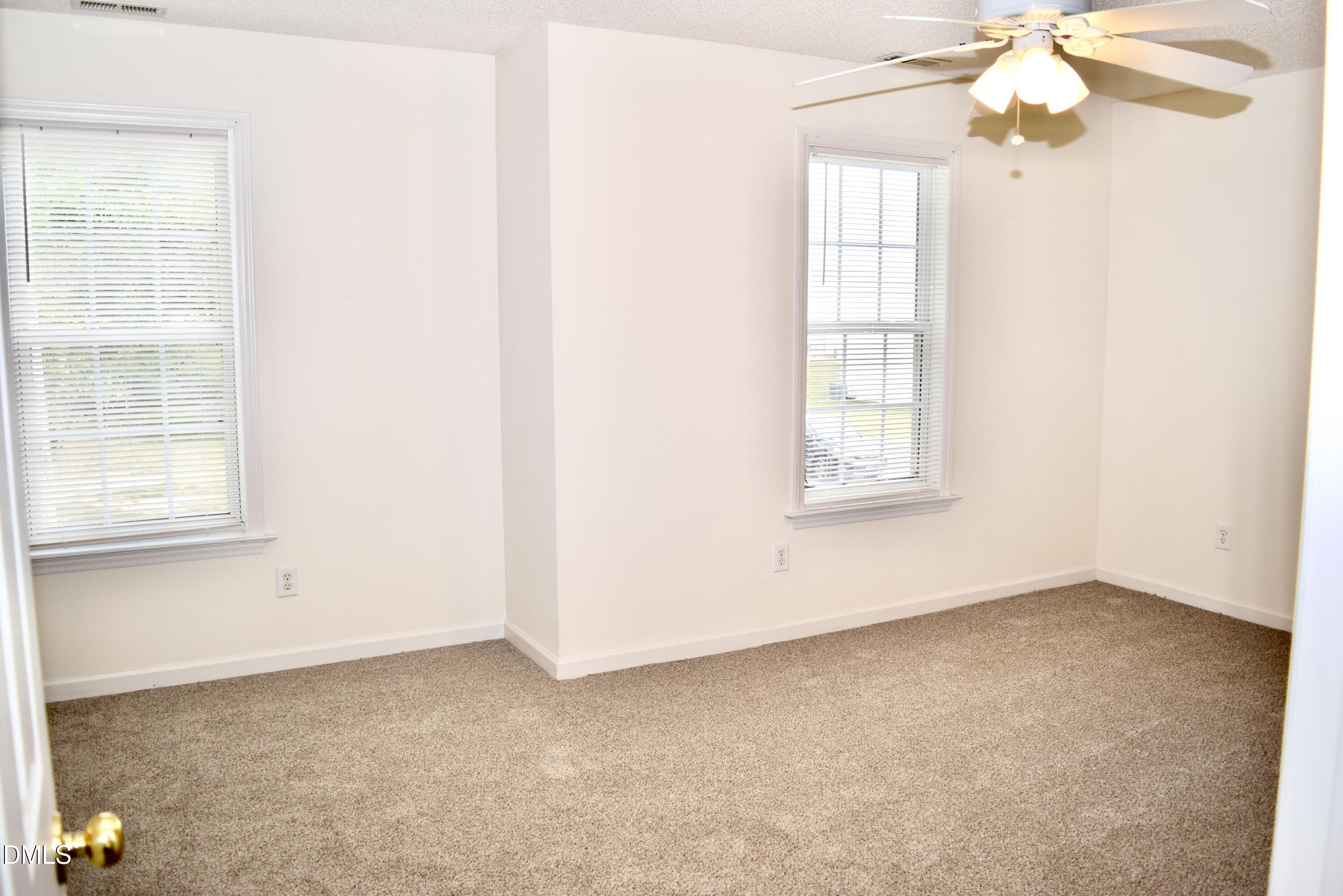 5100 Mass Rock Drive Raleigh, NC 27610 - Photo 18 of 30 an empty room with windows and fan