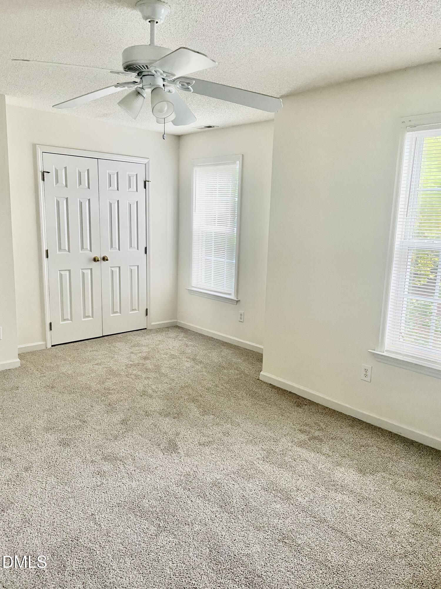 5100 Mass Rock Drive Raleigh, NC 27610 - Photo 19 of 30 an empty room with windows and fan
