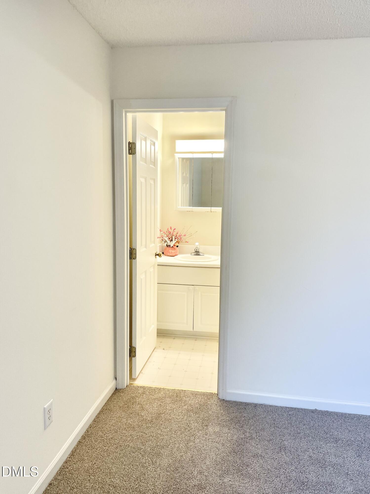 5100 Mass Rock Drive Raleigh, NC 27610 - Photo 20 of 30 a view of a hallway with a white cabinet and a refrigerator